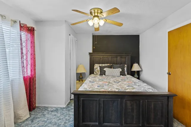 a bedroom with a bed and a chandelier