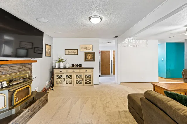 a bedroom with furniture and a flat screen tv