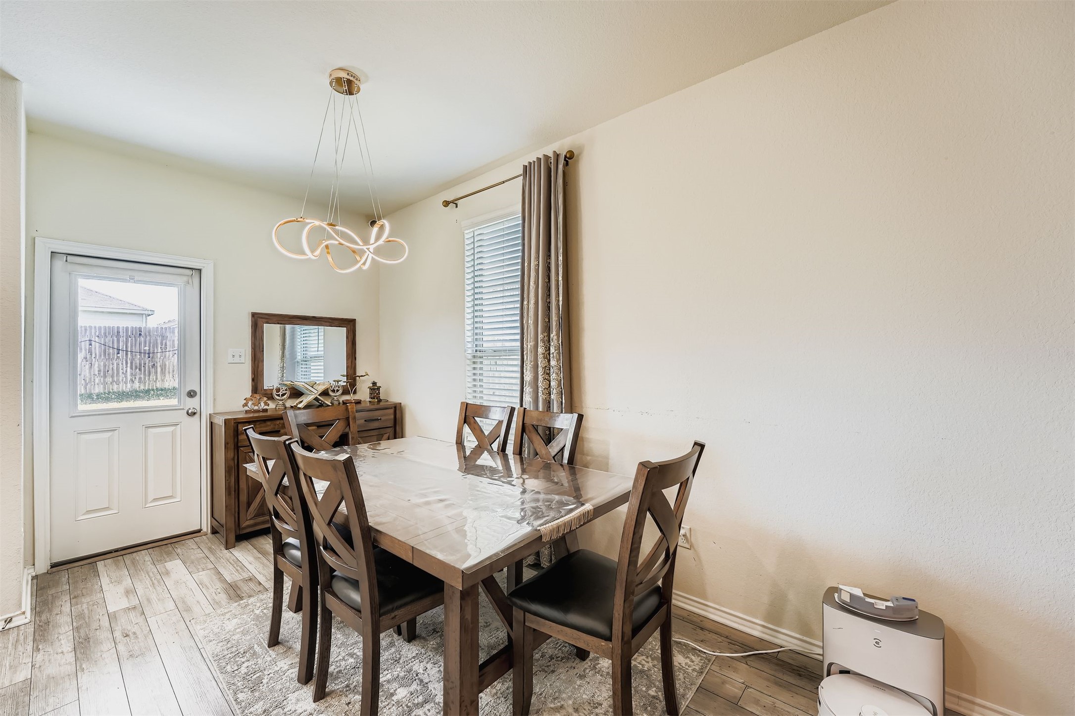 144 Gunther Way Taylor, TX 76574 - Photo 10 of 29 a view of a dining room with furniture and wooden floor