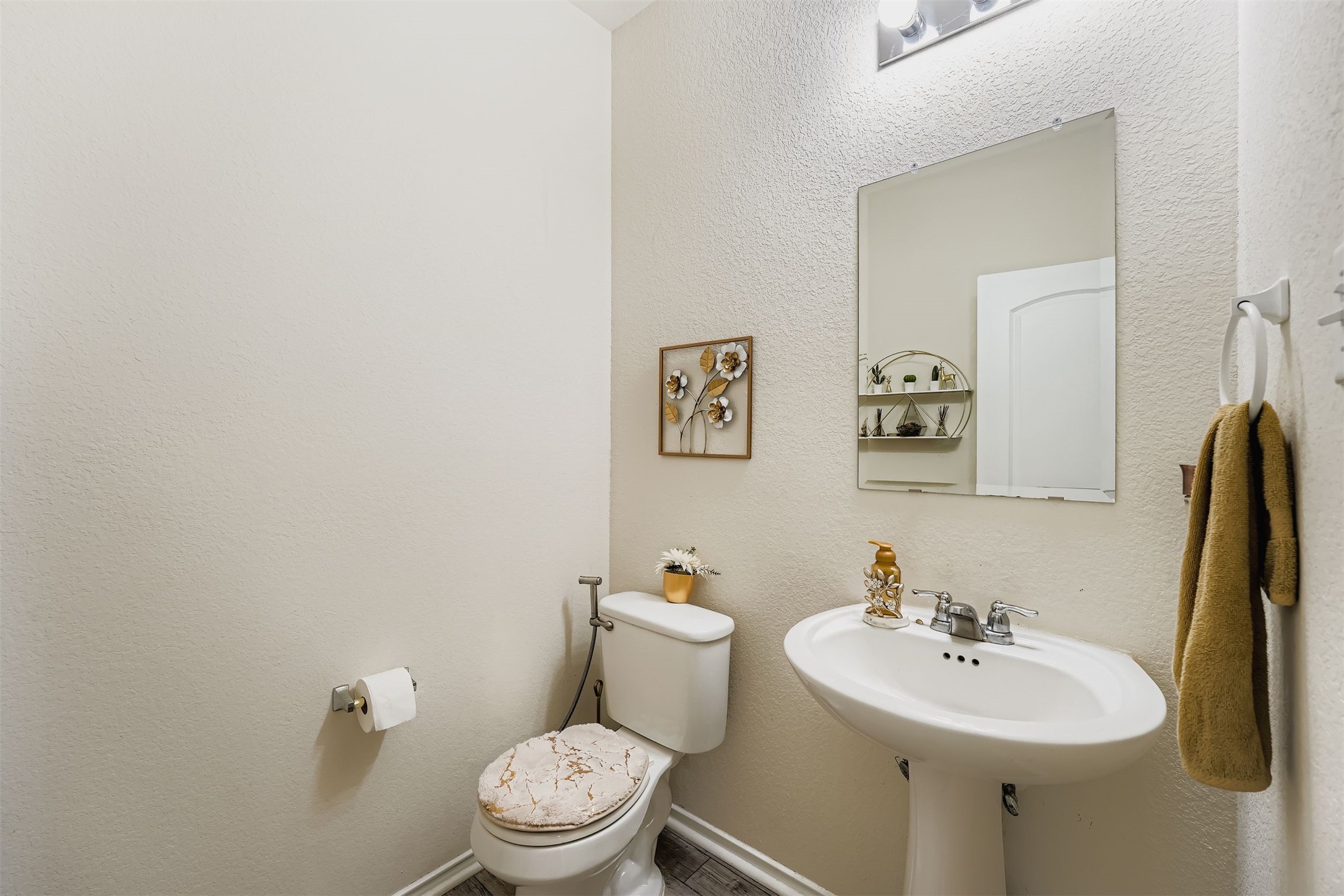 144 Gunther Way Taylor, TX 76574 - Photo 11 of 29 a bathroom with a sink mirror and toilet