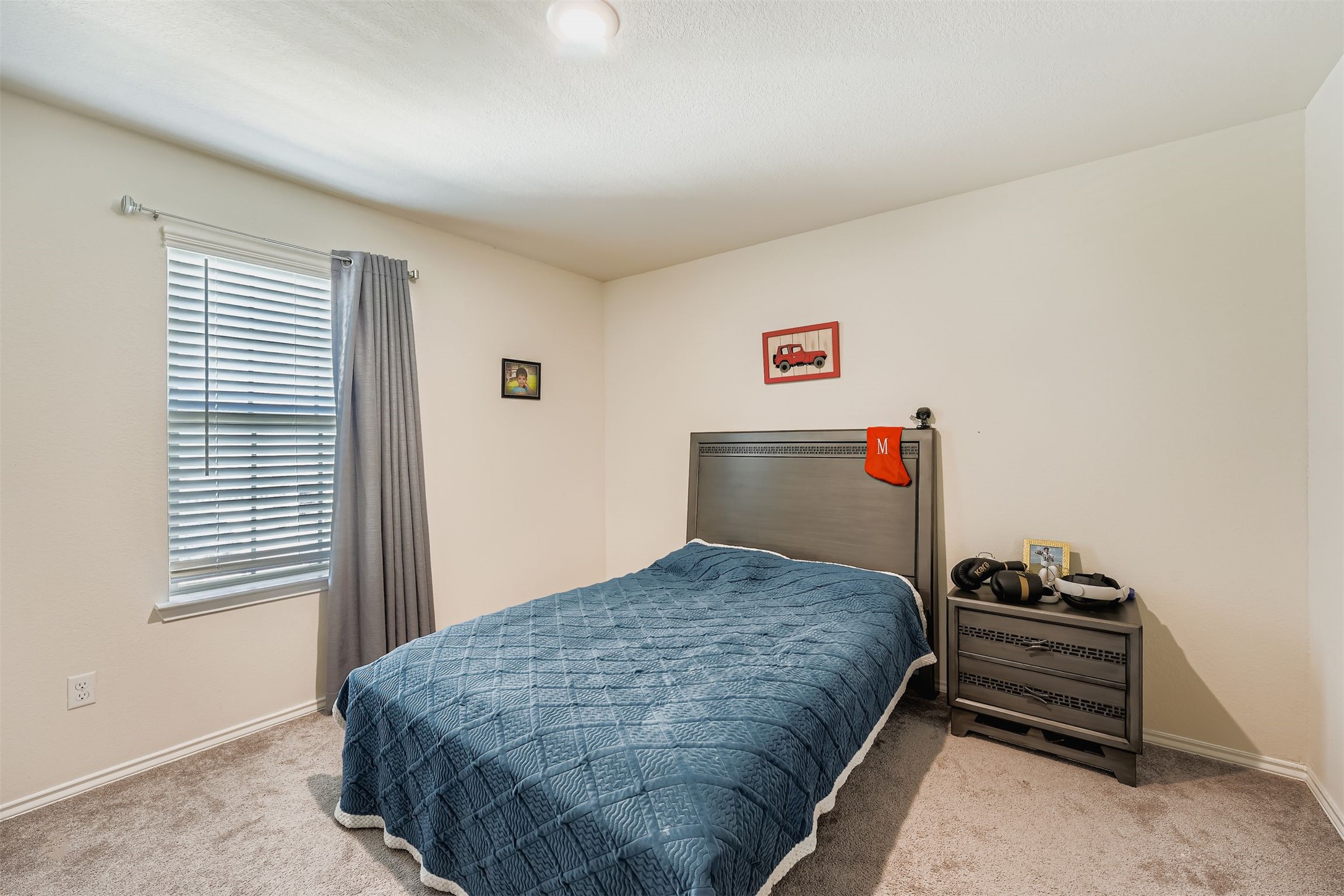 144 Gunther Way Taylor, TX 76574 - Photo 16 of 29 a bedroom with a bed and a window