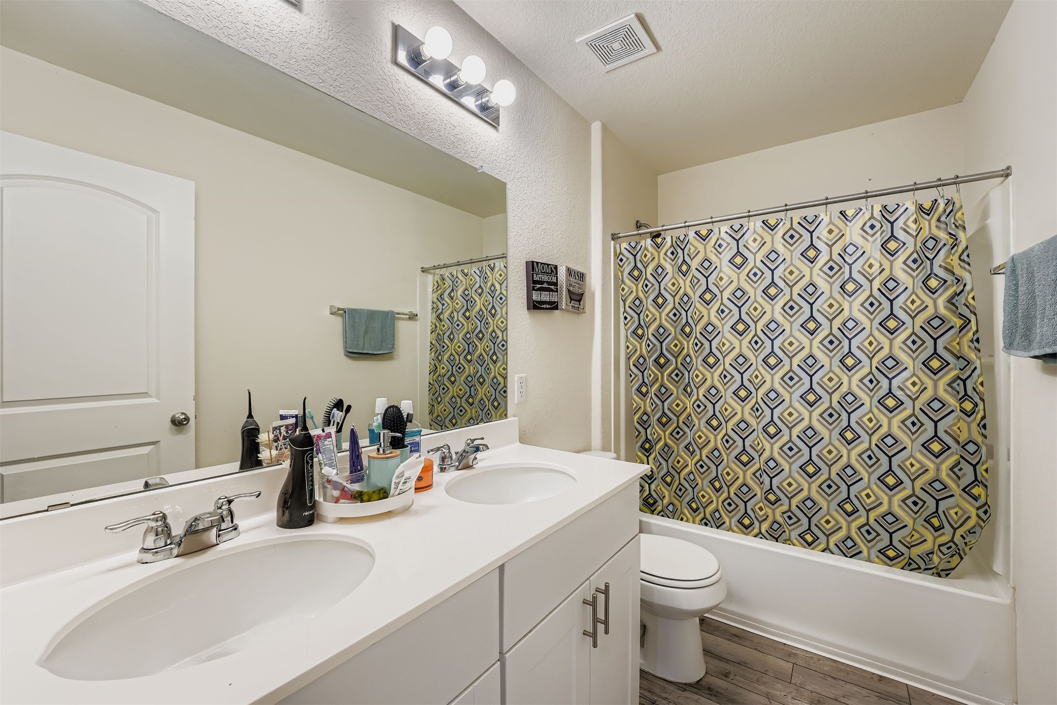 144 Gunther Way Taylor, TX 76574 - Photo 17 of 29 a bathroom with a sink a toilet and shower curtain