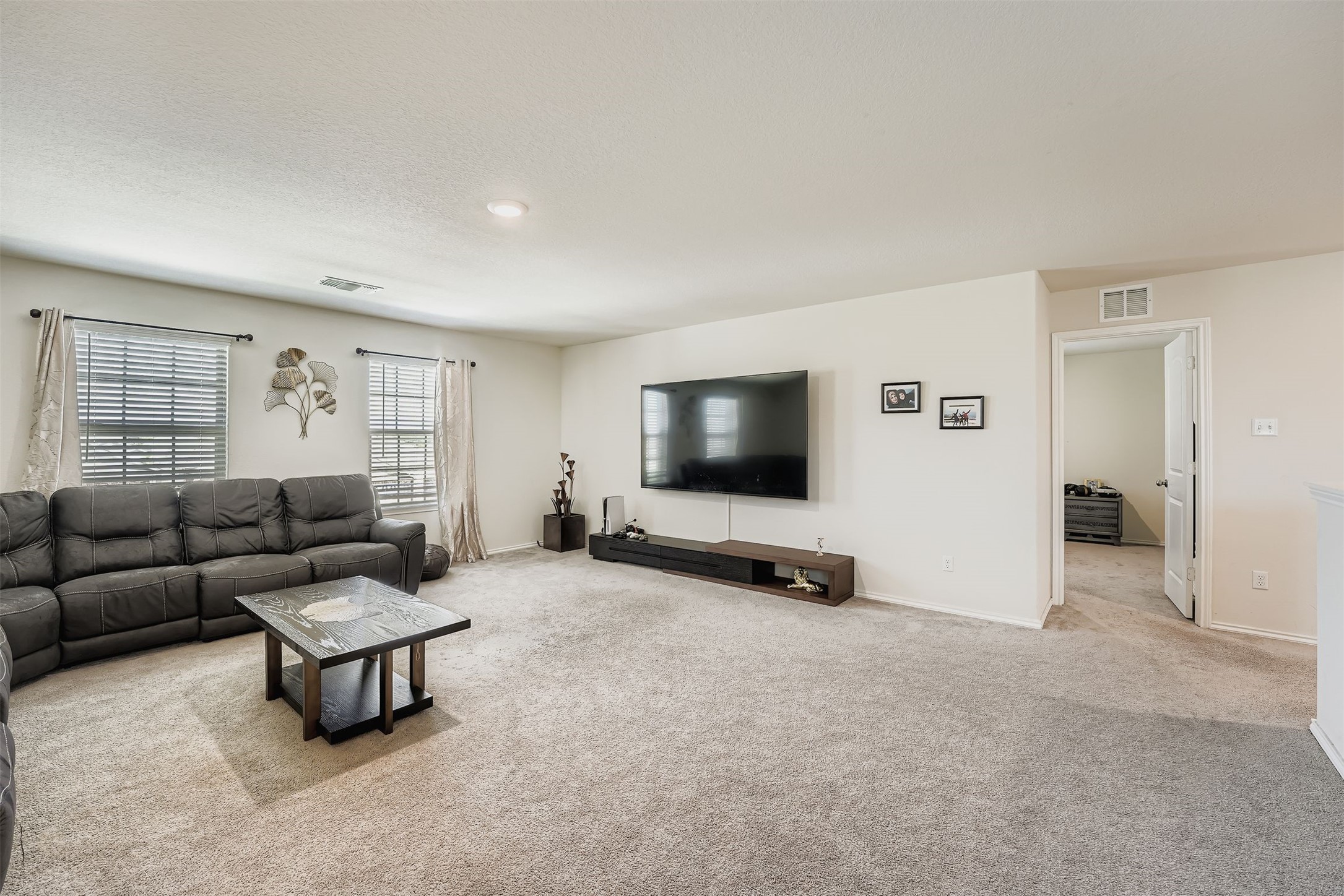 144 Gunther Way Taylor, TX 76574 - Photo 18 of 29 a living room with furniture and a flat screen tv