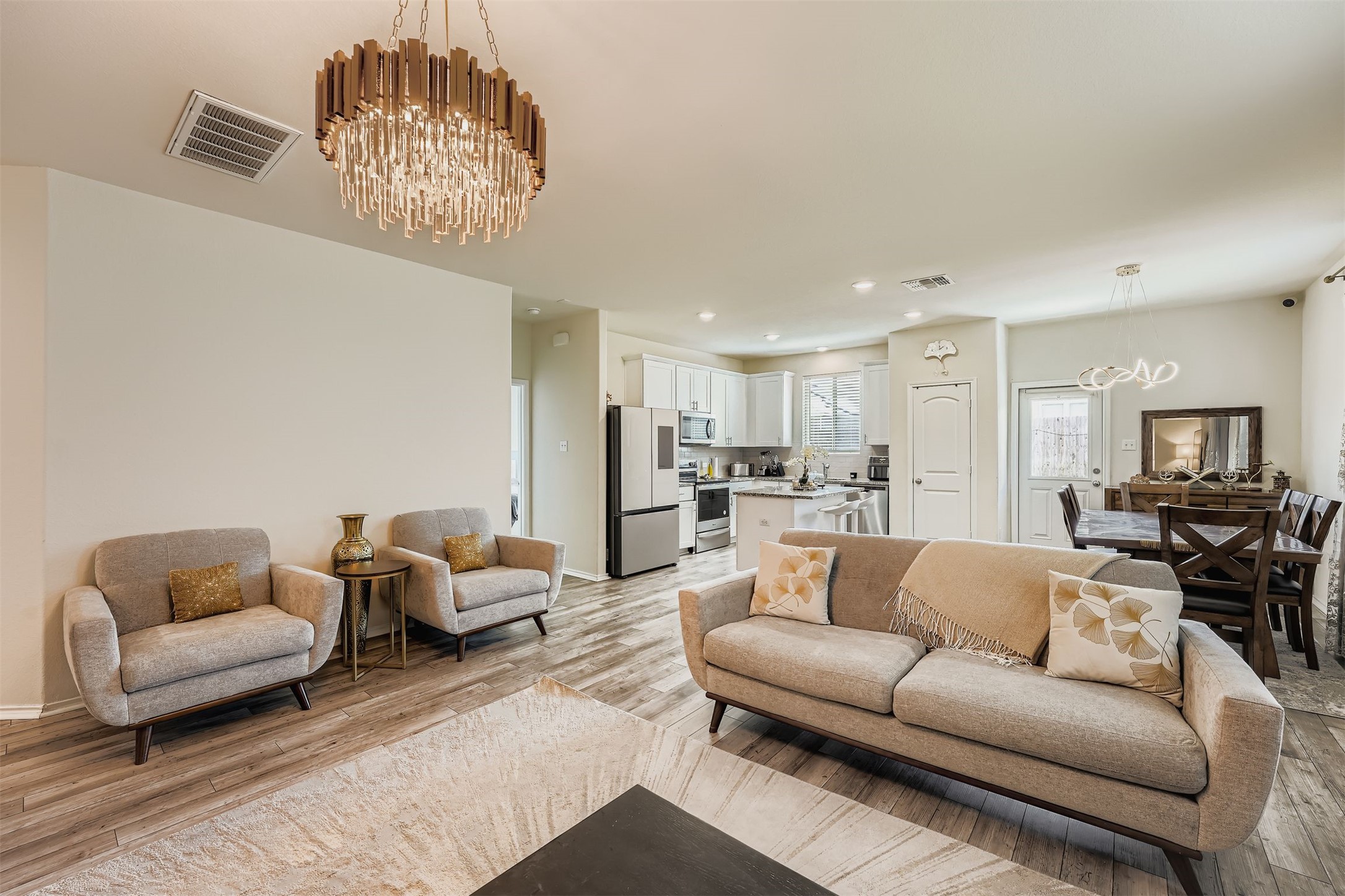 144 Gunther Way Taylor, TX 76574 - Photo 4 of 29 a living room with furniture and a chandelier
