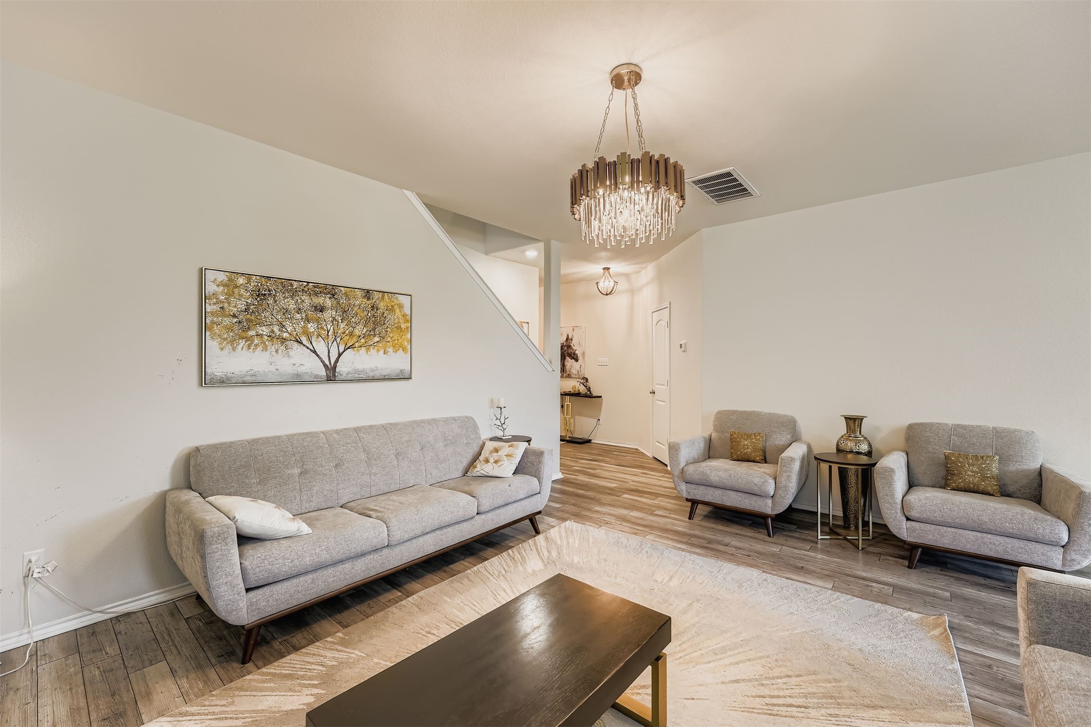 144 Gunther Way Taylor, TX 76574 - Photo 5 of 29 a living room with furniture and a chandelier