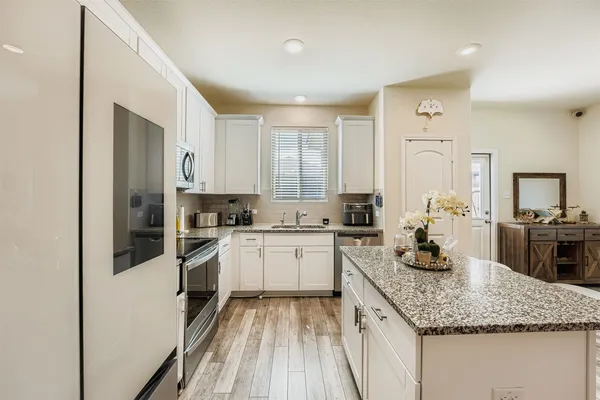 a kitchen with a sink stove and refrigerator
