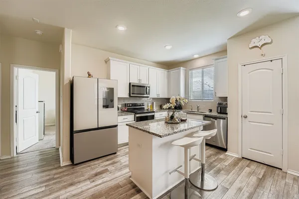 a kitchen with sink a stove and cabinets