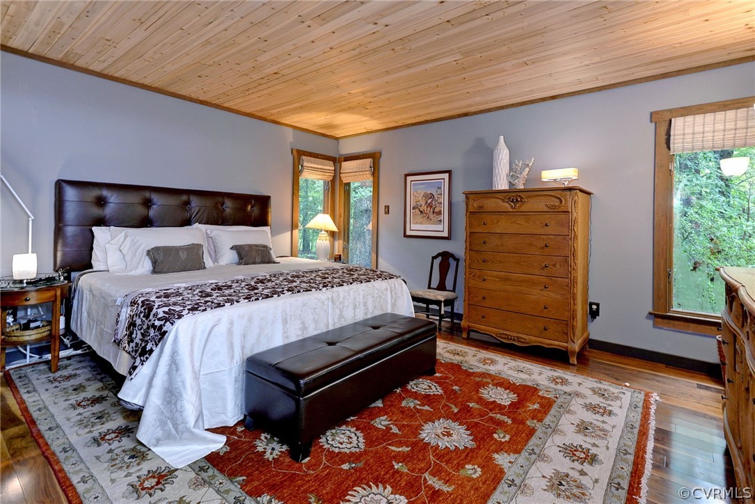 125 Rte 1601 Williamsburg, VA 23188 - Photo 24 of 46 a bedroom with a bed and wooden floor
