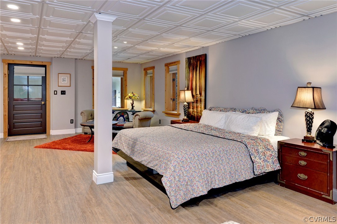 125 Rte 1601 Williamsburg, VA 23188 - Photo 36 of 46 a bedroom with a bed and wooden floor