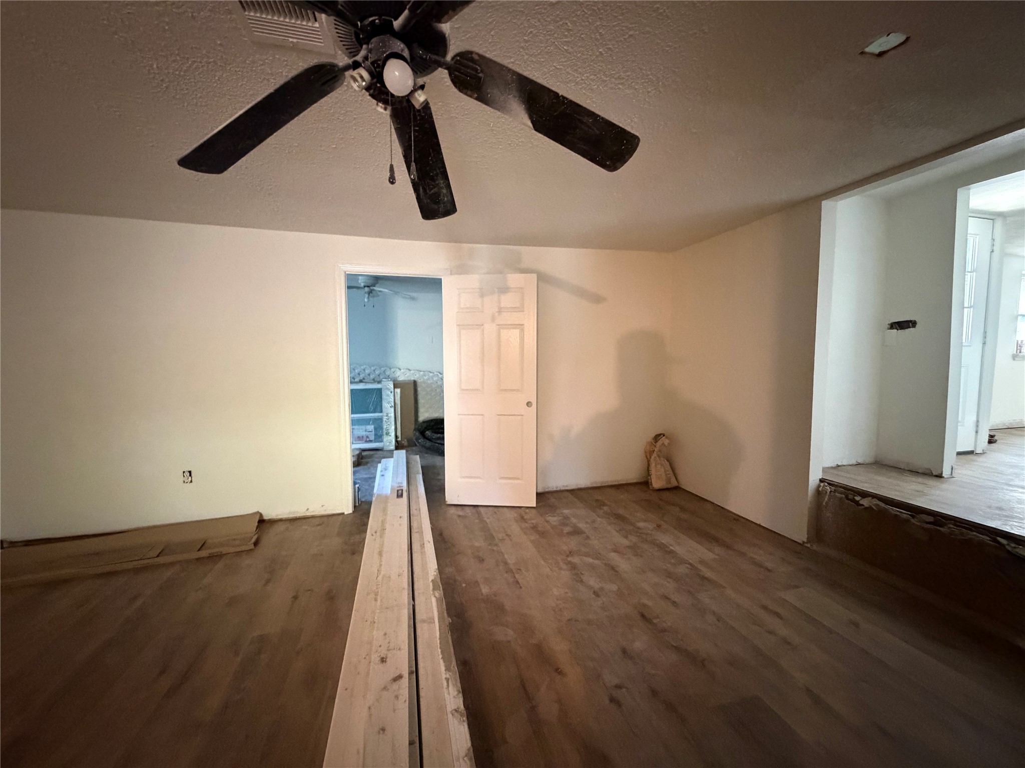 915 West Lewis Street Conroe, TX 77301 - Photo 3 of 6 a view of a big room with wooden floor and windows