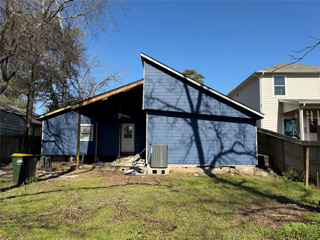 a view of a backyard with chairs and a tree