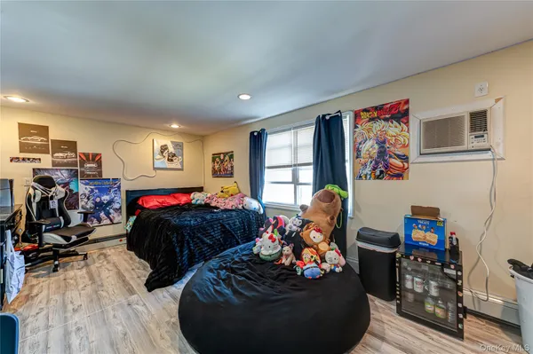 a living room with furniture a window and wooden floor