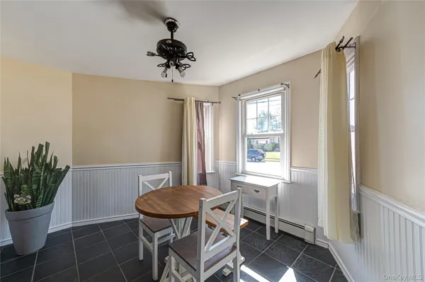 a view of a dining room with furniture and window