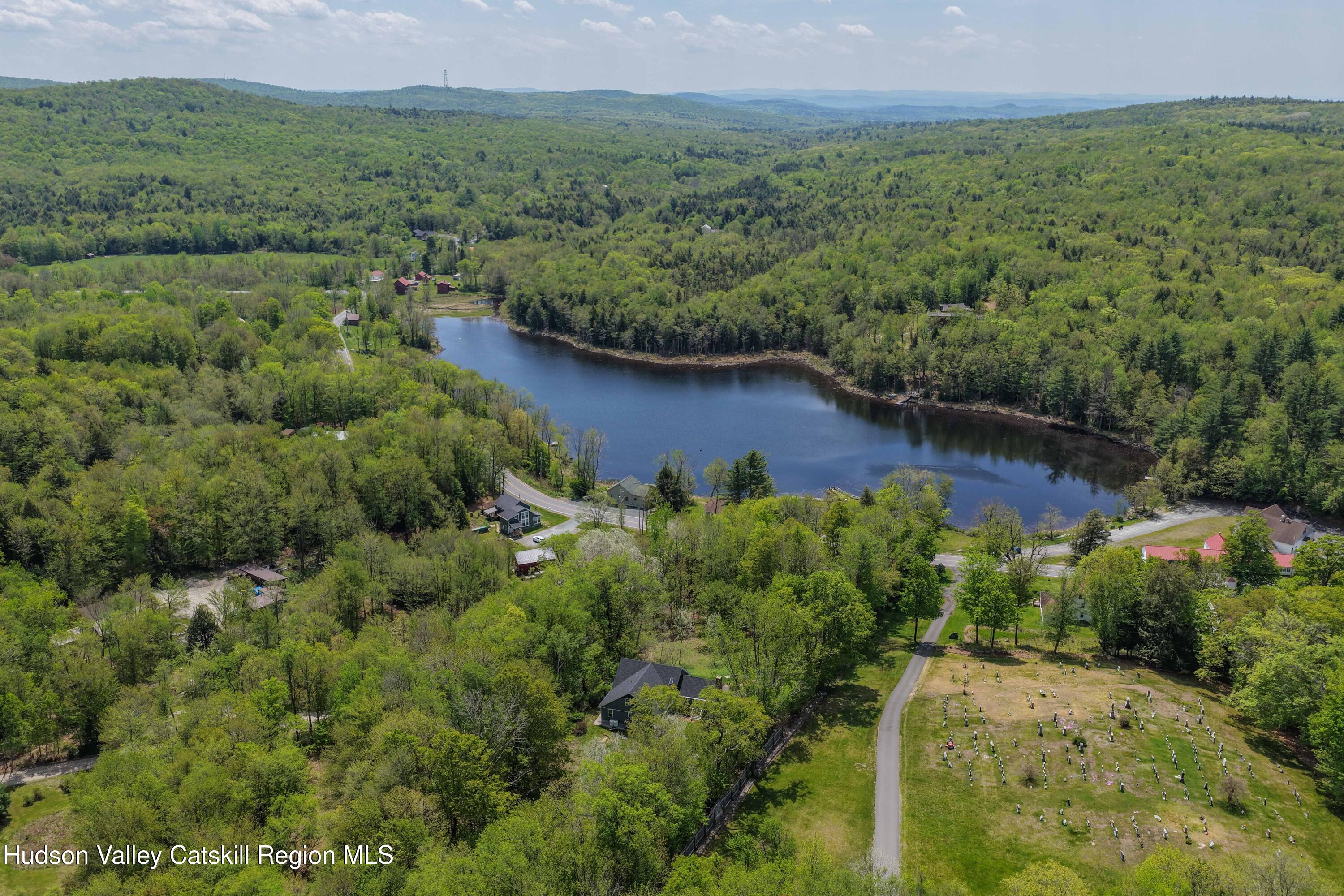 757 Taborton Road Sand Lake, NY 12153 - Photo 28 of 32 a view of a lake with green field and mountains