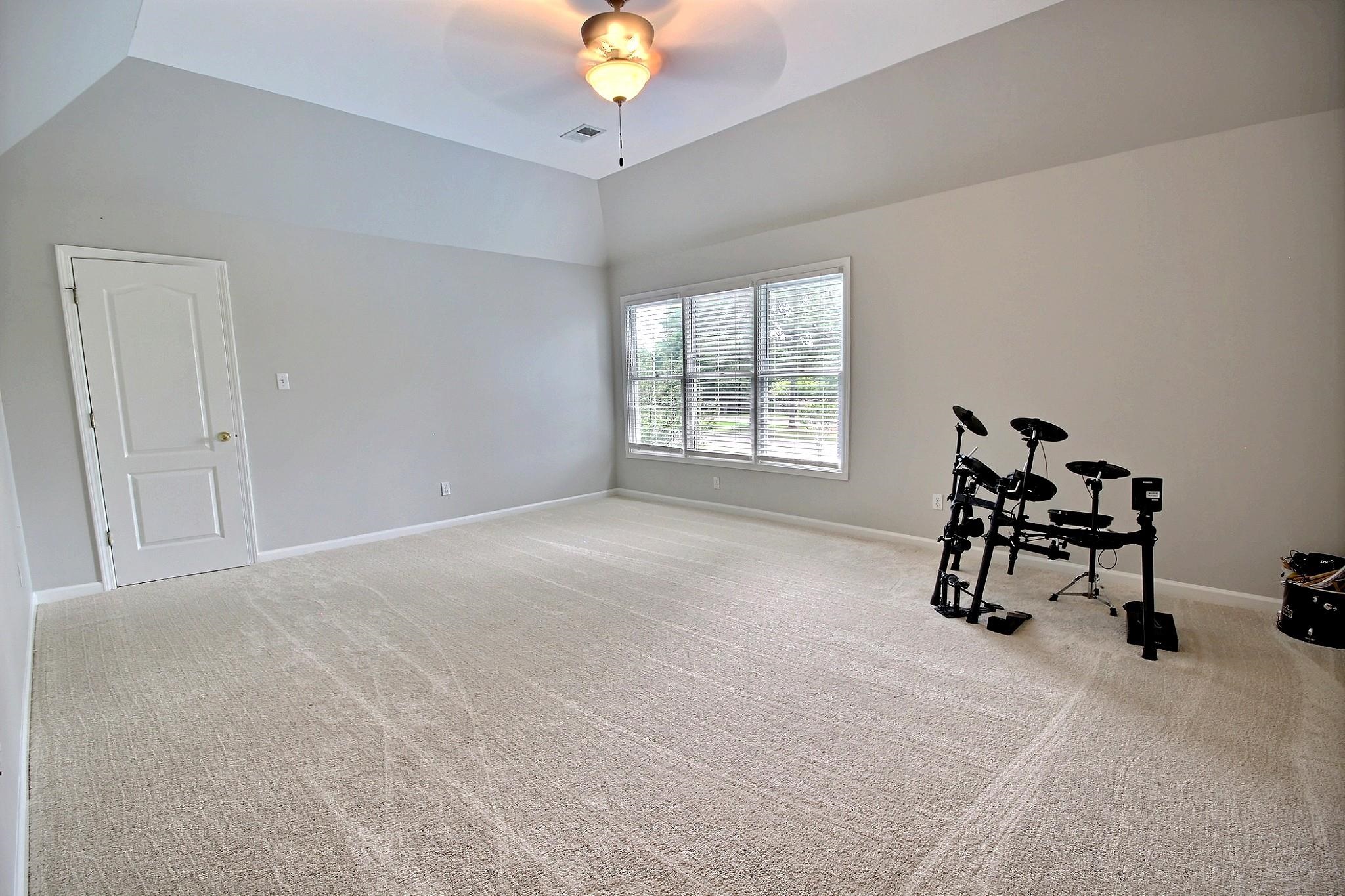 1050 Stanhope Road Collierville, TN 38017 - Photo 25 of 31 an empty room with windows and fan
