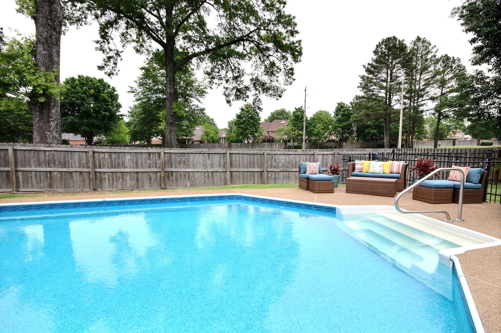 1050 Stanhope Road Collierville, TN 38017 - Photo 28 of 31 a view of a swimming pool with a bench and trees
