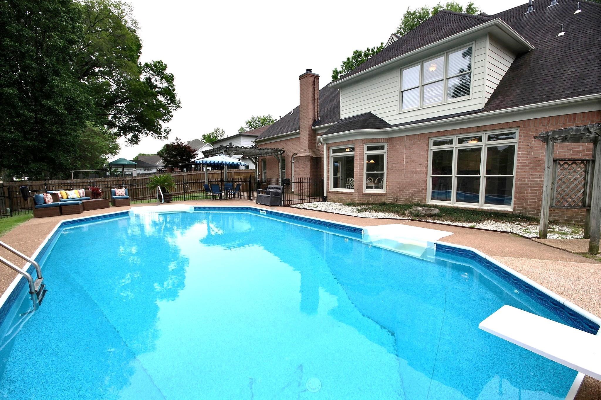 1050 Stanhope Road Collierville, TN 38017 - Photo 29 of 31 a view of a house with pool and chairs