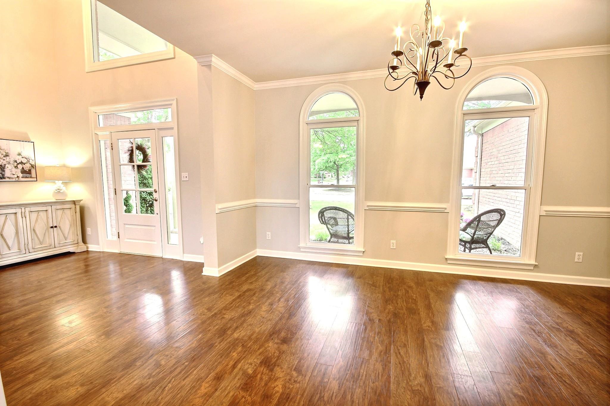 1050 Stanhope Road Collierville, TN 38017 - Photo 3 of 31 a view of an empty room with wooden floor and a window
