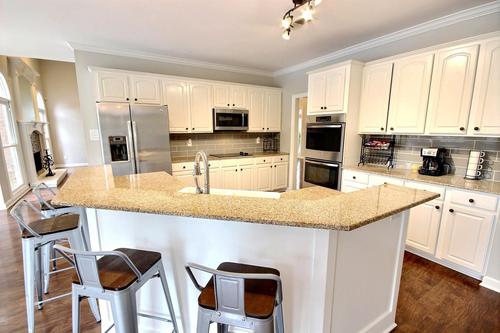 1050 Stanhope Road Collierville, TN 38017 - Photo 10 of 31 a kitchen with stainless steel appliances granite countertop a sink and a refrigerator