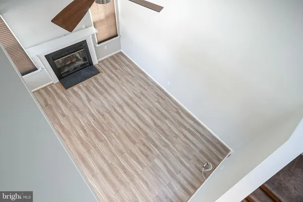 a view of an empty room with a fireplace and a window
