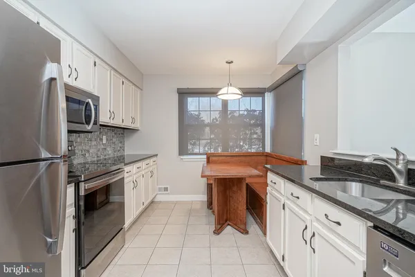 a kitchen with a sink and a window