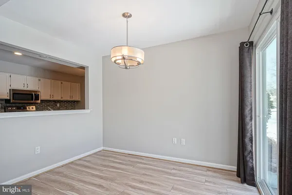 wooden floor fireplace and windows in an empty room