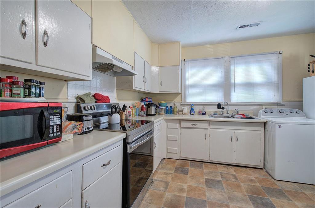 2009 North Broad Street Rome, GA 30161 - Photo 7 of 22 a kitchen with sink cabinets and window