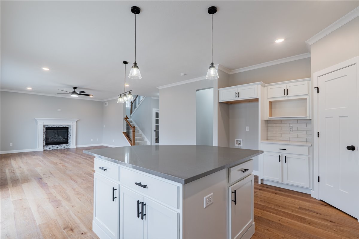 5206 Finlen Lane Bloomington, IL 61705 - Photo 14 of 40 a kitchen with a sink a chandelier and wooden floor
