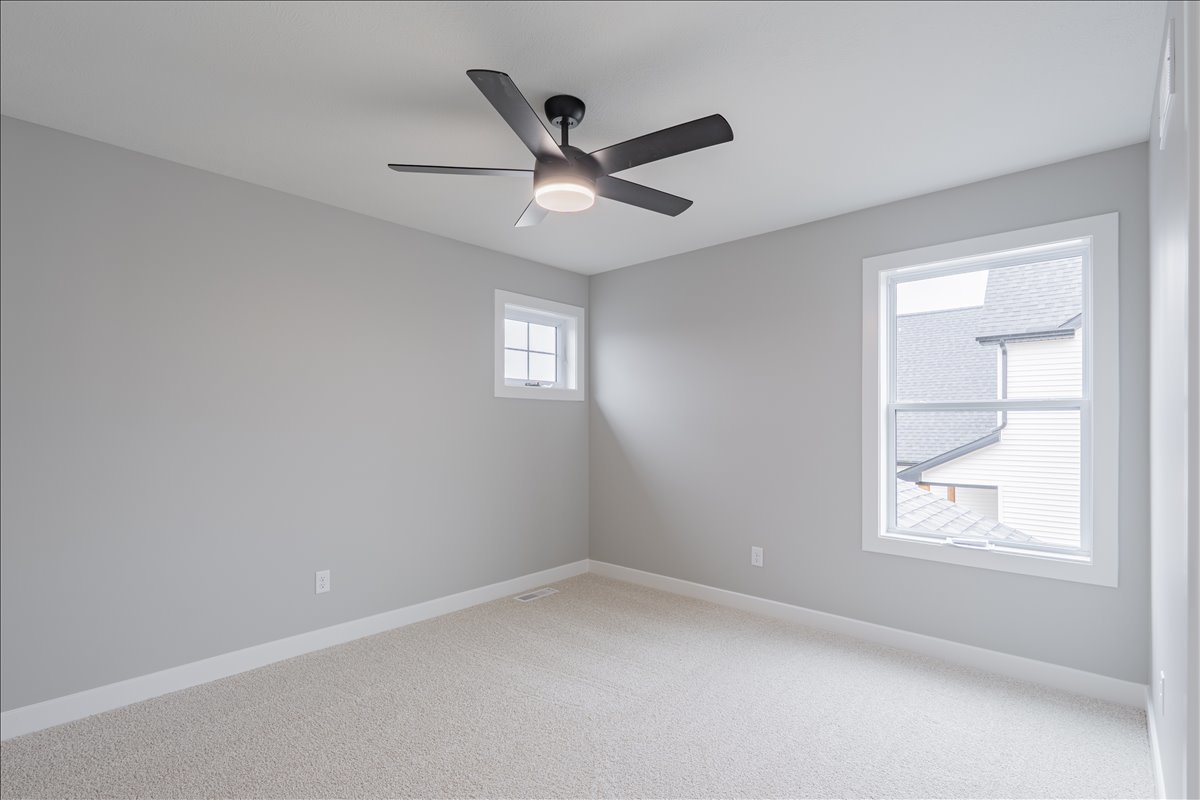 5206 Finlen Lane Bloomington, IL 61705 - Photo 22 of 40 an empty room with windows and fan