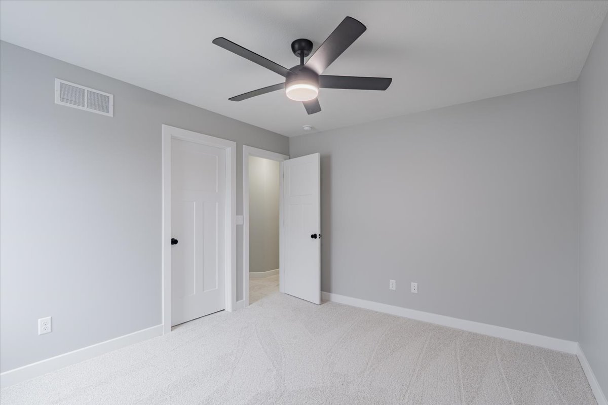 5206 Finlen Lane Bloomington, IL 61705 - Photo 23 of 40 an empty room with ceiling fan and window
