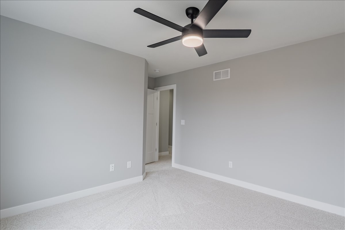 5206 Finlen Lane Bloomington, IL 61705 - Photo 27 of 40 an empty room with a ceiling fan and a ceiling fan