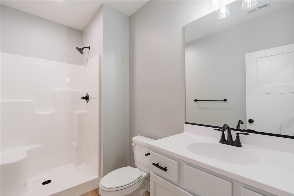 5206 Finlen Lane Bloomington, IL 61705 - Photo 33 of 40 a bathroom with a sink a toilet and shower