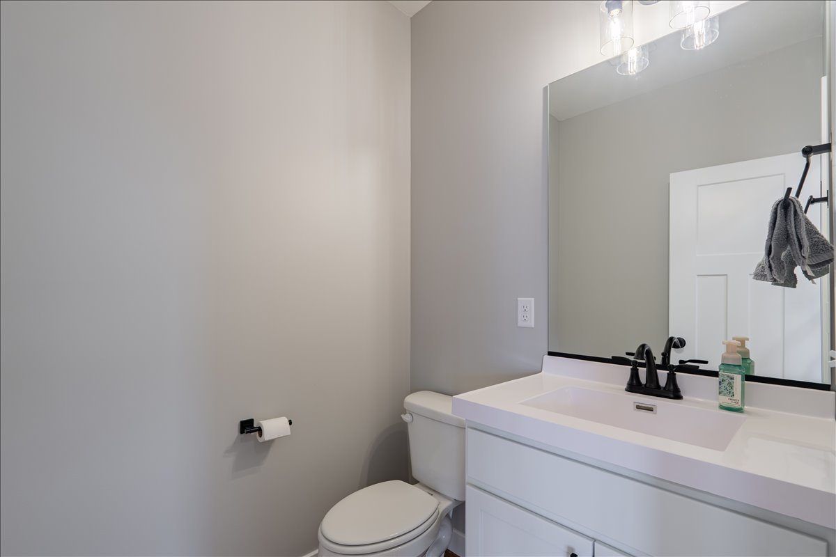5206 Finlen Lane Bloomington, IL 61705 - Photo 6 of 40 a bathroom with a sink a toilet and mirror