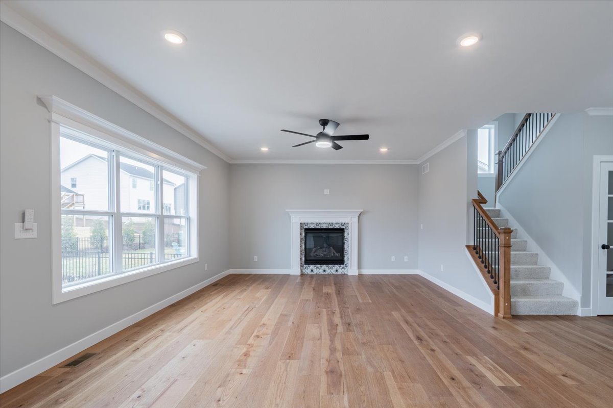 5206 Finlen Lane Bloomington, IL 61705 - Photo 8 of 40 a view of an empty room with wooden floor fireplace and a window