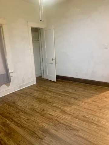 a view of wooden floor and brick wall