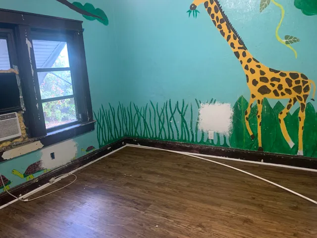 a view of a room with wooden floor and windows