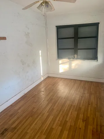 a view of room with wooden floor and window