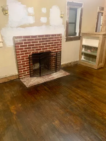 a view of fireplace and wooden floor