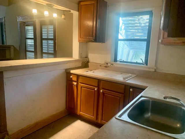 a kitchen with a sink cabinets and window