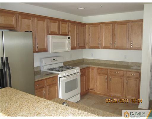 23 Raritan Reach Road South Amboy, NJ 08879 - Photo 5 of 14 a kitchen with a stove sink and cabinets