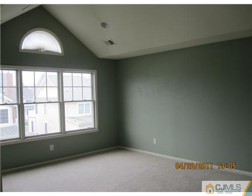 23 Raritan Reach Road South Amboy, NJ 08879 - Photo 7 of 14 an empty room with wooden floor and windows
