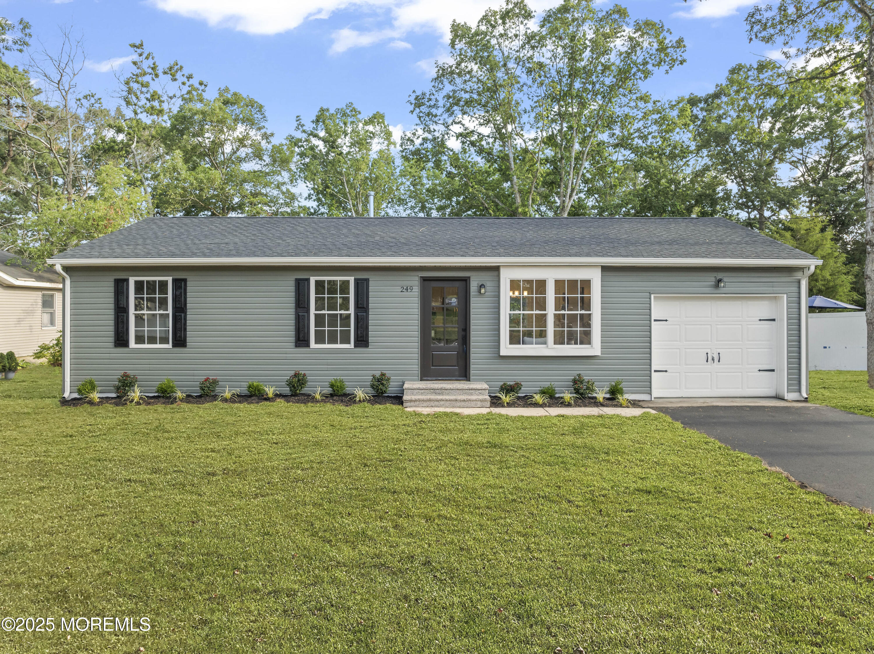249 Crows Nest Road Manahawkin, NJ 08050 - Photo 1 of 21 a front view of a house with a garden
