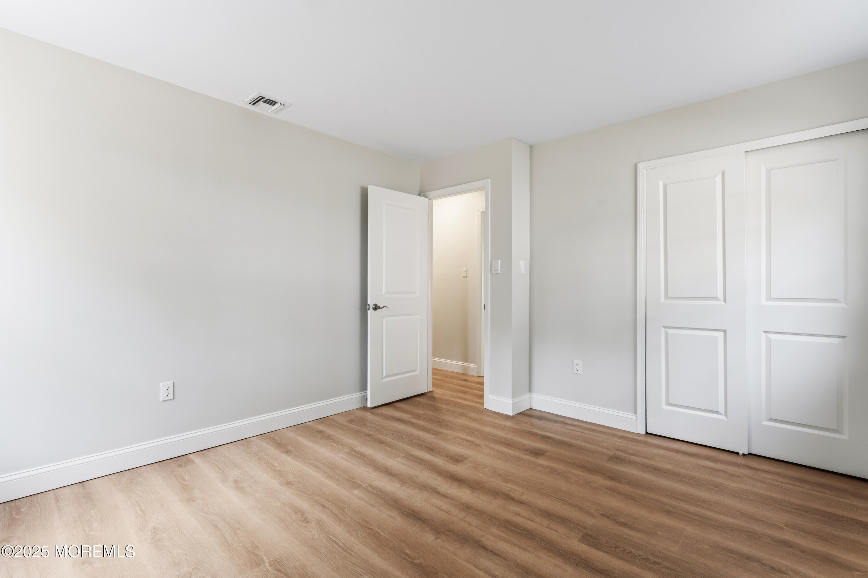 249 Crows Nest Road Manahawkin, NJ 08050 - Photo 18 of 21 a view of an empty room and wooden floor