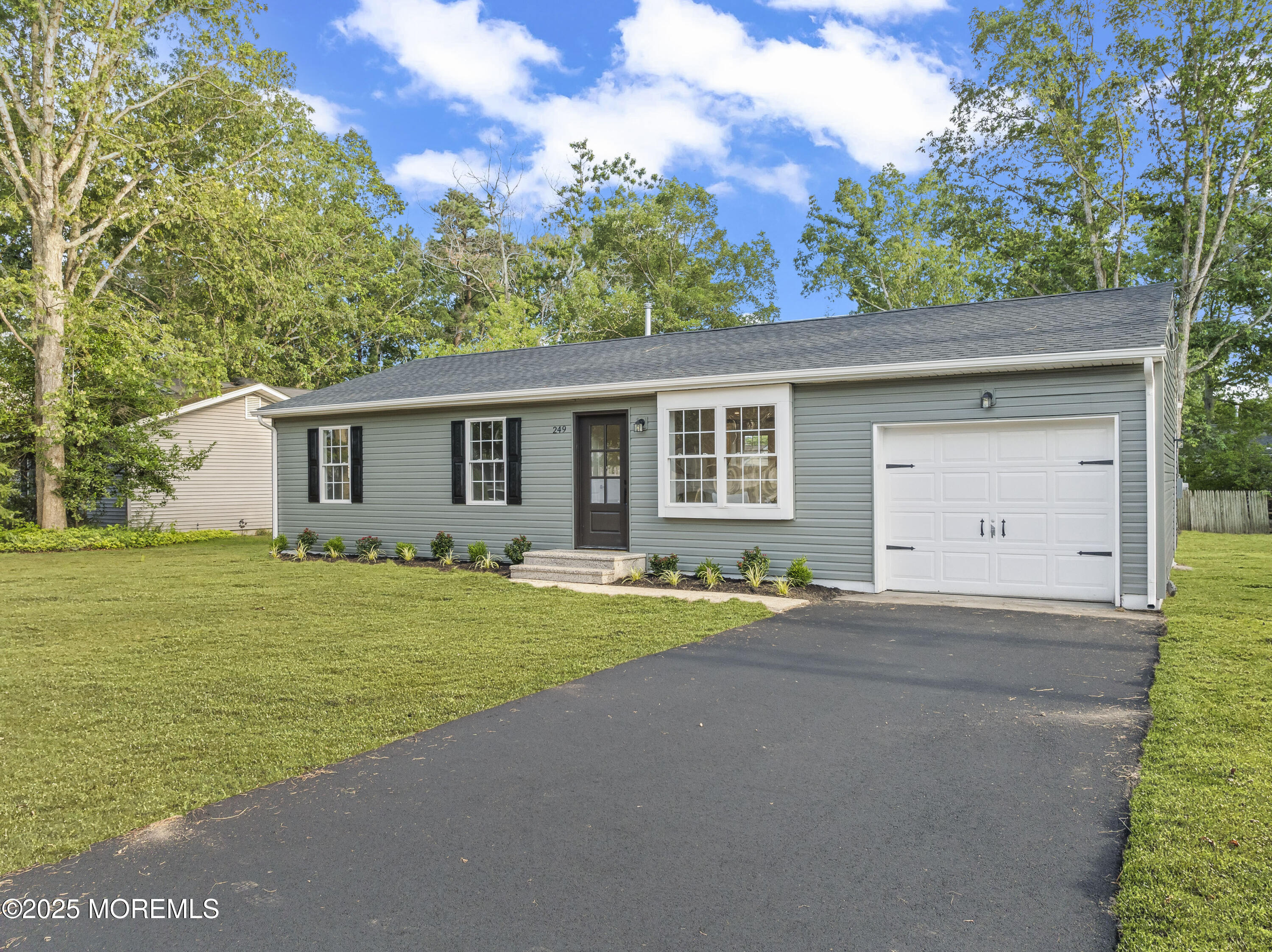 249 Crows Nest Road Manahawkin, NJ 08050 - Photo 20 of 21 a front view of a house with a yard and garage