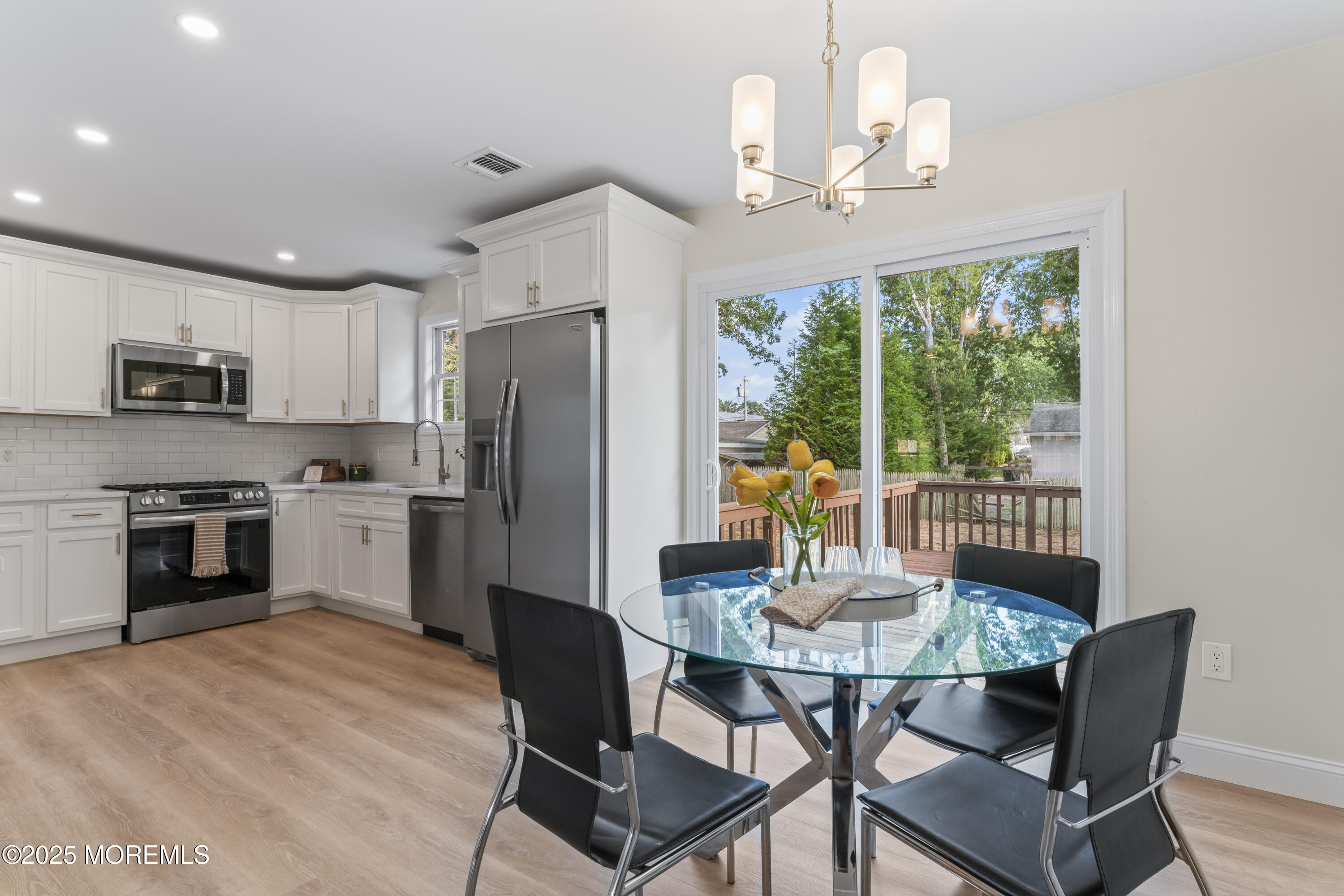 249 Crows Nest Road Manahawkin, NJ 08050 - Photo 7 of 21 a kitchen with granite countertop a dining table and chairs