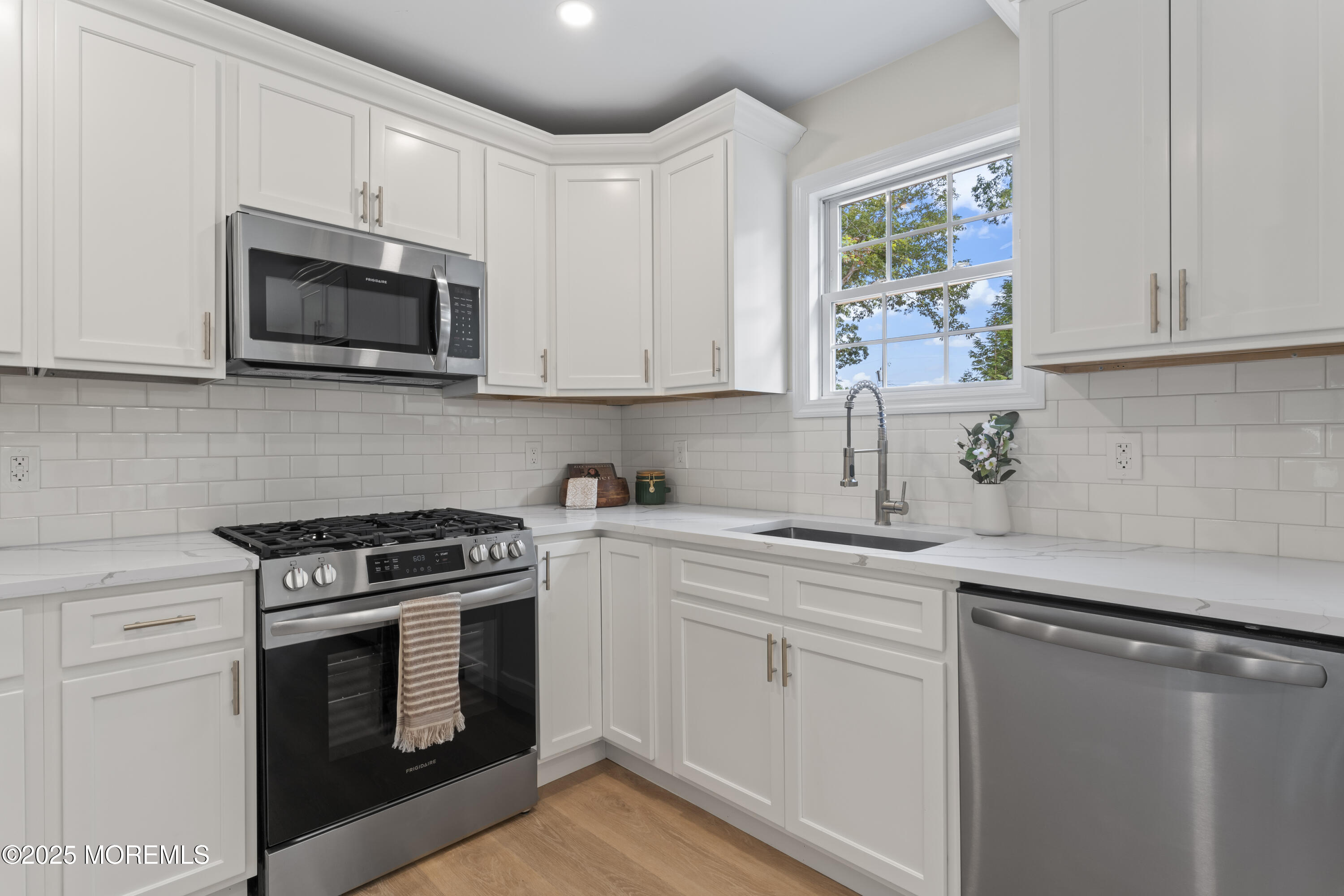 249 Crows Nest Road Manahawkin, NJ 08050 - Photo 10 of 21 a kitchen with white cabinets and stainless steel appliances