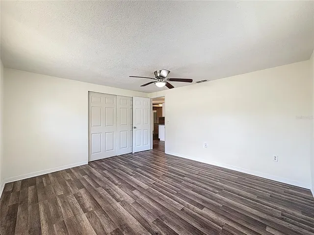 a view of a room with wooden floor