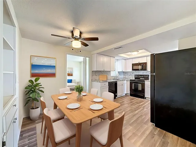 a view of a dining room with furniture and a kitchen