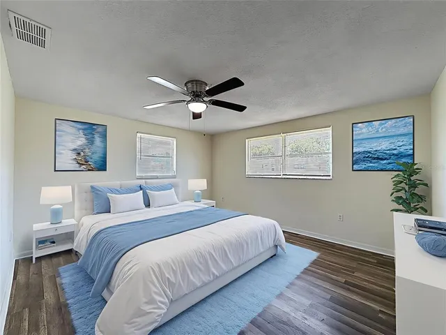 a bedroom with a large bed and a window