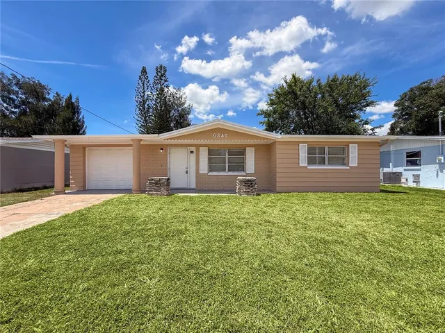 a view of a house with a back yard
